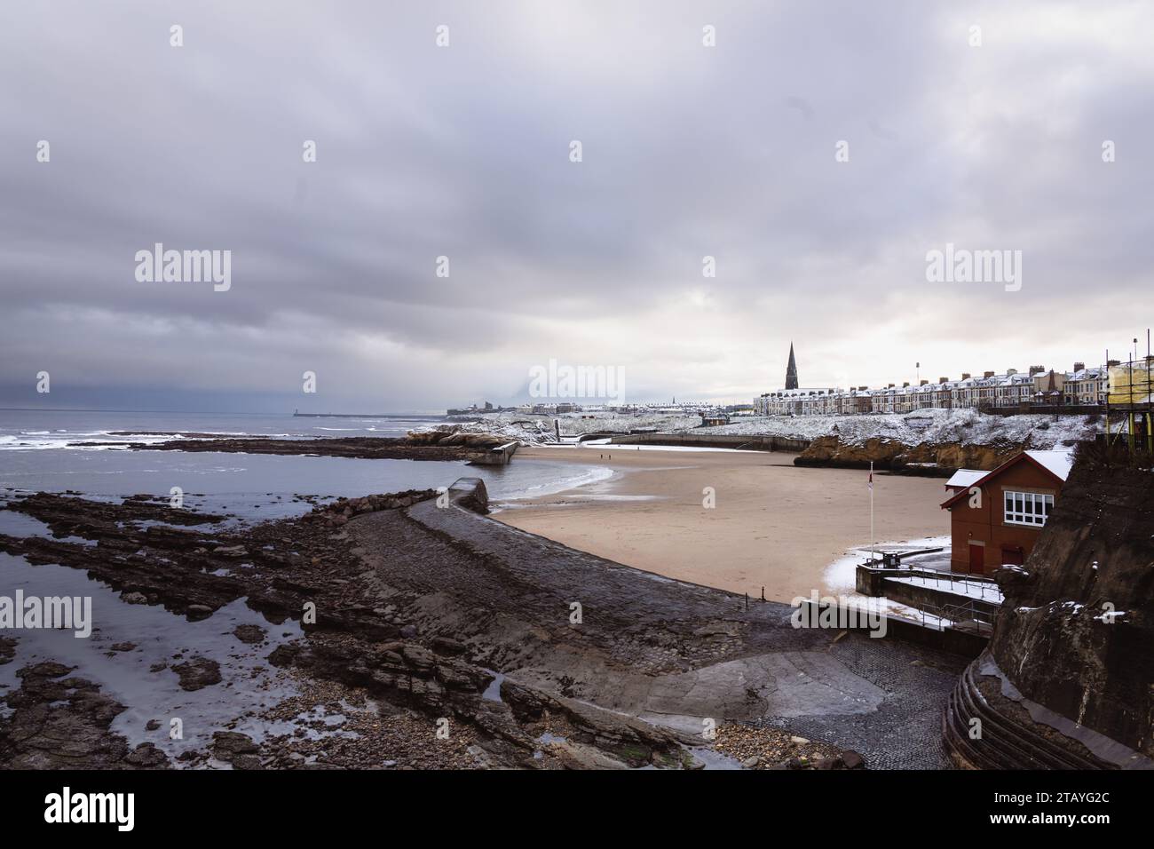 Cullercoats Bay with some snow on the beach and views of the RNLI and ...