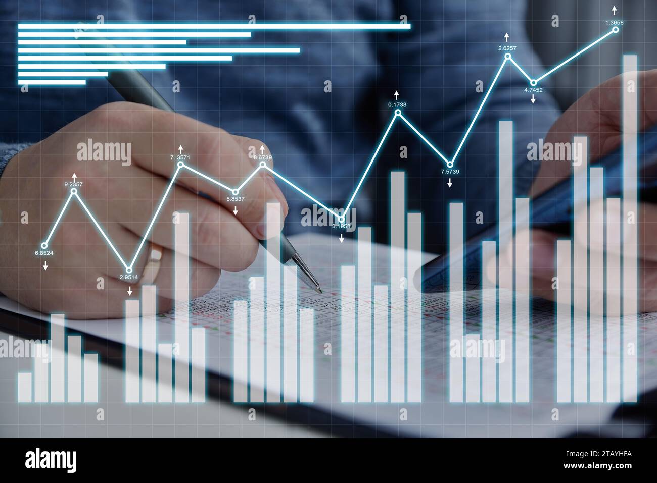 Businessman checks financial report with statistics and investment analytic hologram. Internet trading and business  concept. Close up Stock Photo
