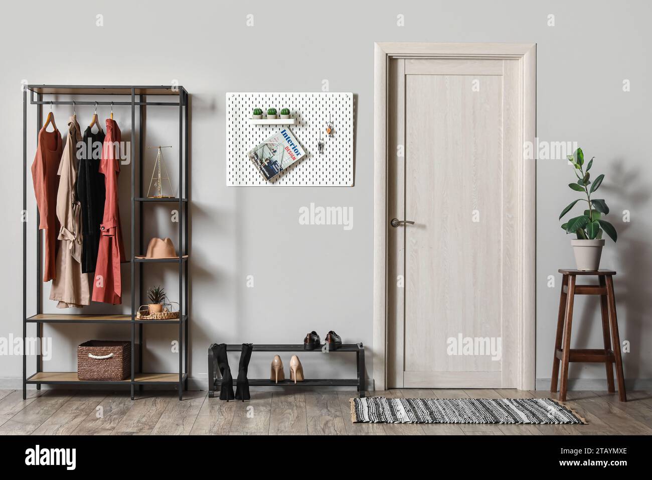 Interior of hall with pegboard, clothes rack and shoe stand Stock Photo