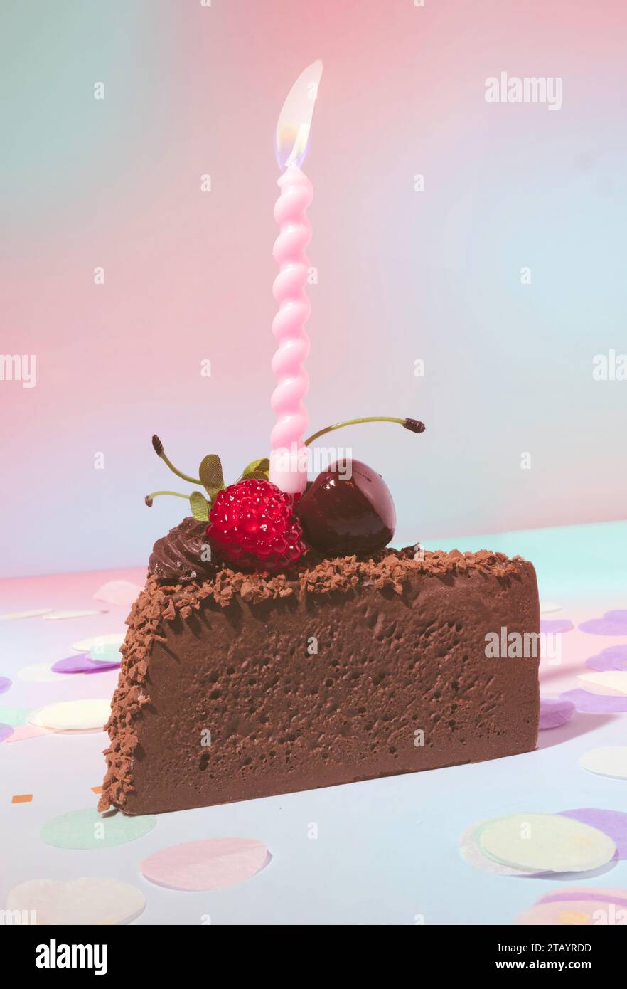 A Slice of Chocolate Birthday Cake with Lit Candles on a Soft, Pastel ...