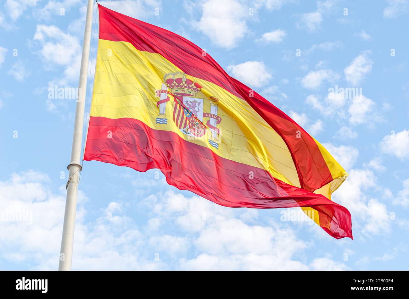 Spanish flag waving in the wind on cloudy blue sky background Stock ...