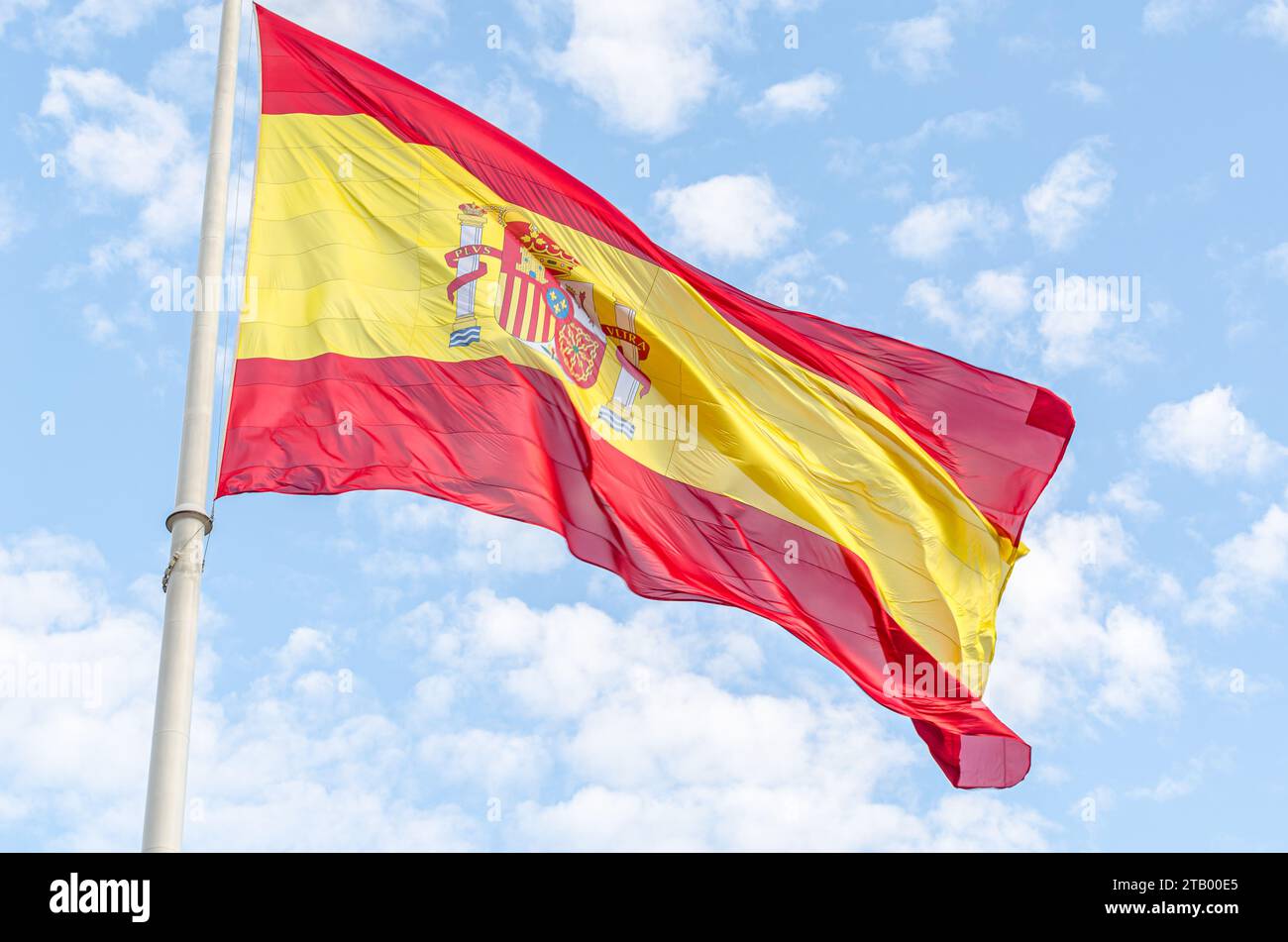 Spanish flag waving in the wind on cloudy blue sky background Stock ...