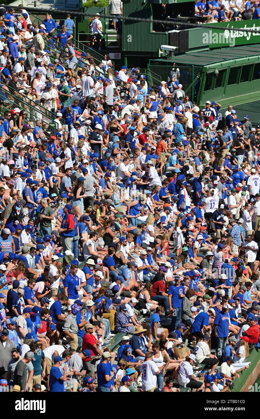 Chicago, Illinois, USA. Fans in the bleachers at Wrigley Field, home of the Chicago Cubs. The bleacher seats area is one of numerous landmak features Stock Photo