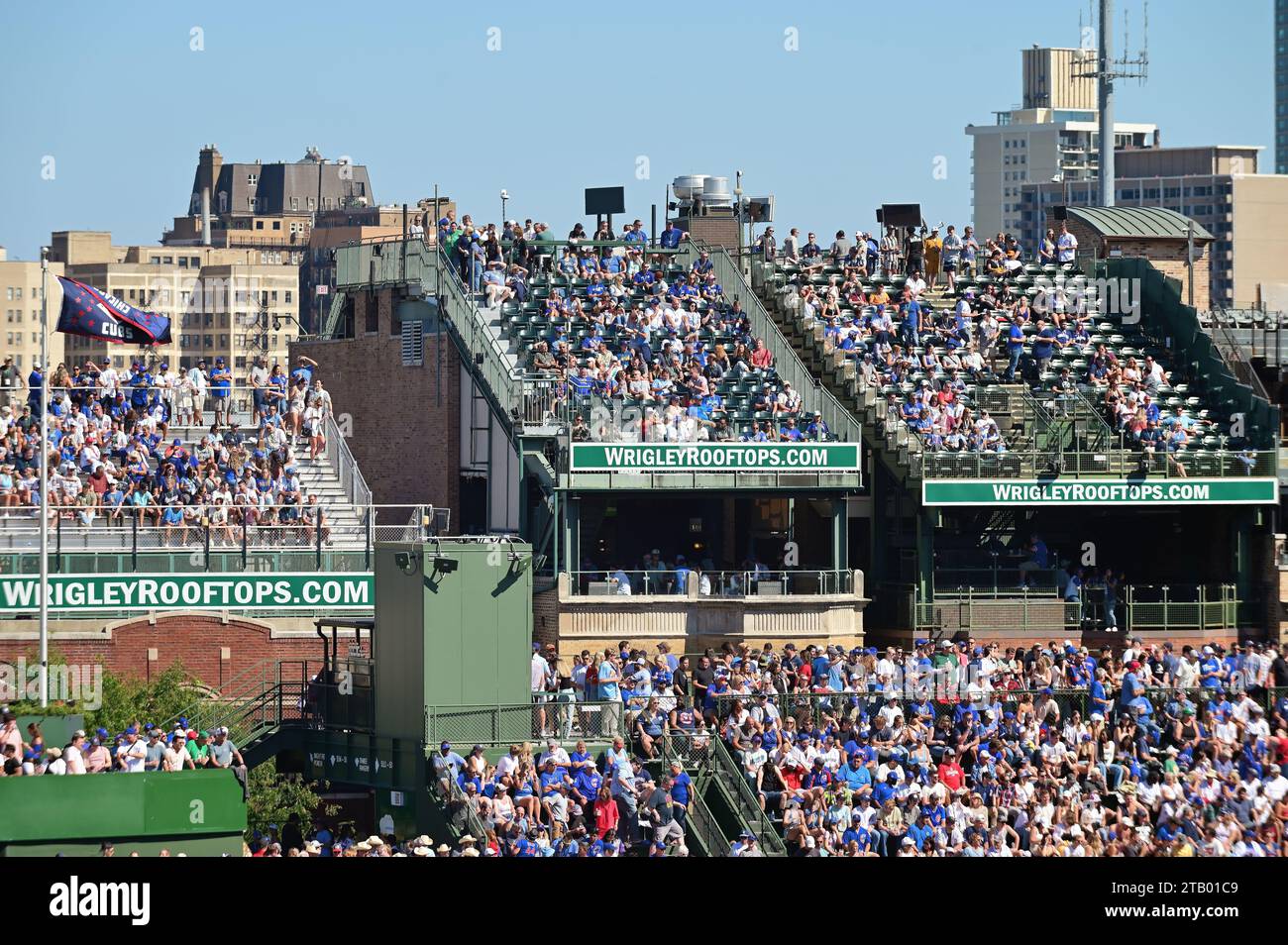 Chicago, Illinois, USA. Fans in the bleachers inside and outside at Wrigley Field, home of the Chicago Cubs during an afternoon game. Stock Photo