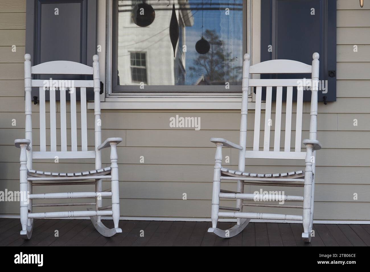 Two white rocking chairs on the front porch. Stock Photo