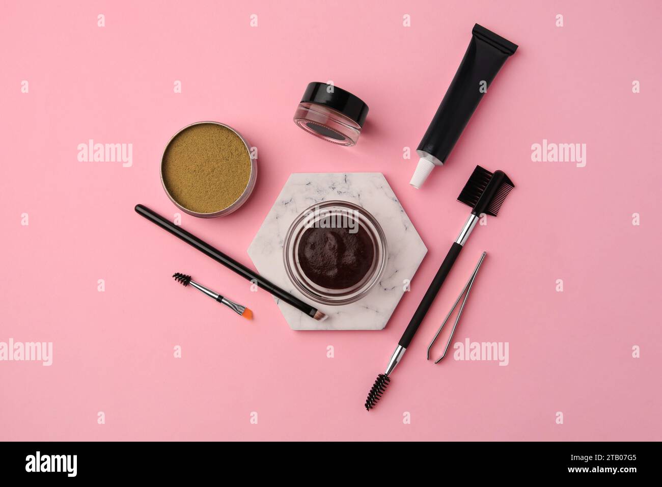 Flat lay composition with eyebrow henna and tools on pink background Stock Photo