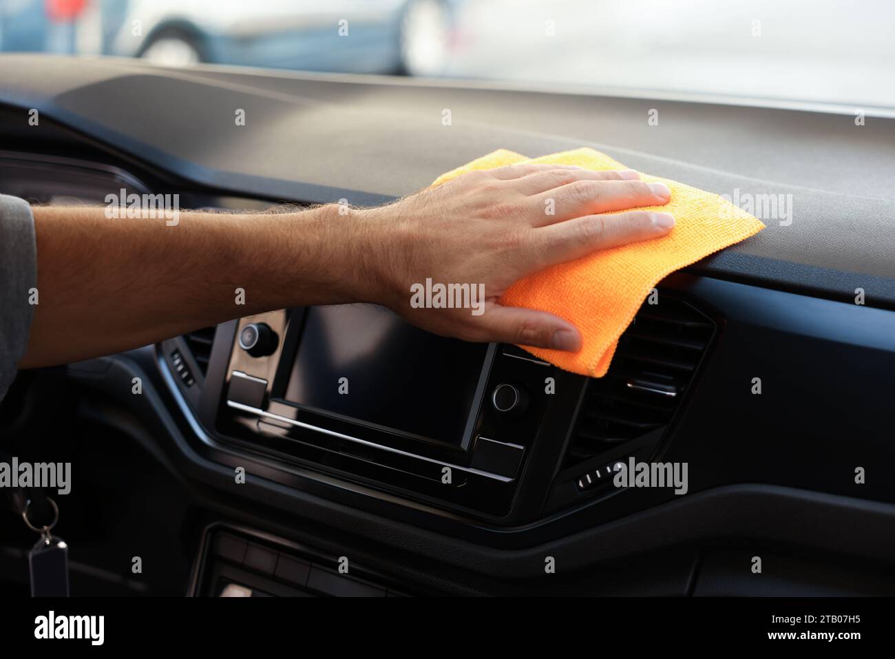 Man cleaning center console with rag in car, closeup Stock Photo - Alamy