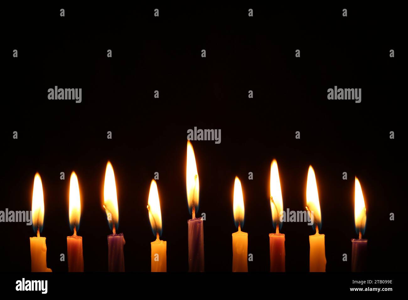 Hanukkah celebration. Burning candles on black background Stock Photo