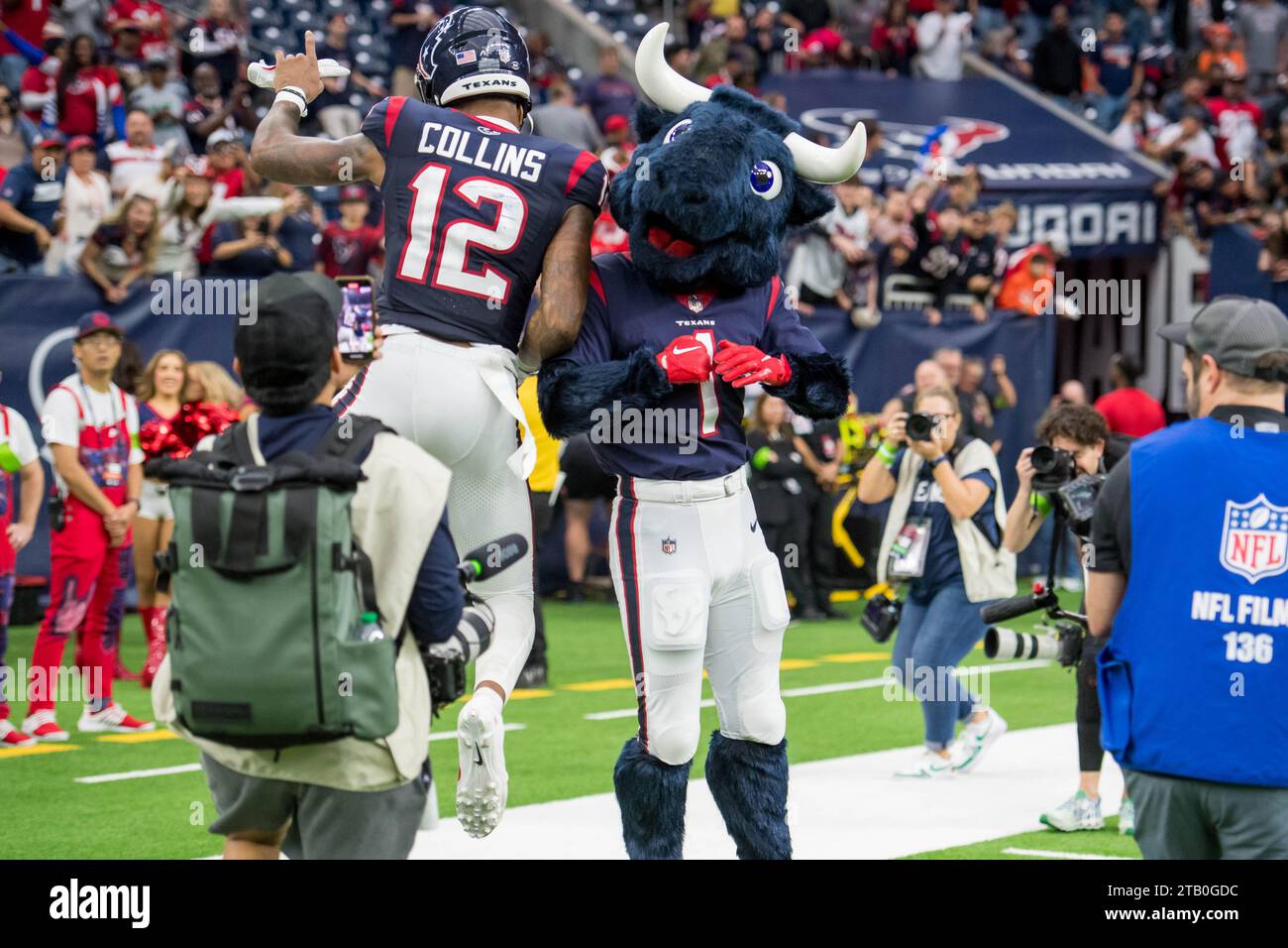 Houston, TX, USA. 3rd Dec, 2023. Houston Texans wide receiver Nico Collins (12) celebrates a win with Houston Texans mascot Toro after a game between the Denver Broncos and the Houston Texans in Houston, TX. Trask Smith/CSM/Alamy Live News Stock Photo
