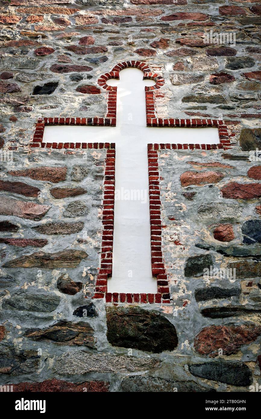 Cross motif above the entrance to the medieval Kemiö Church,  Kemiö, Finland. Stock Photo