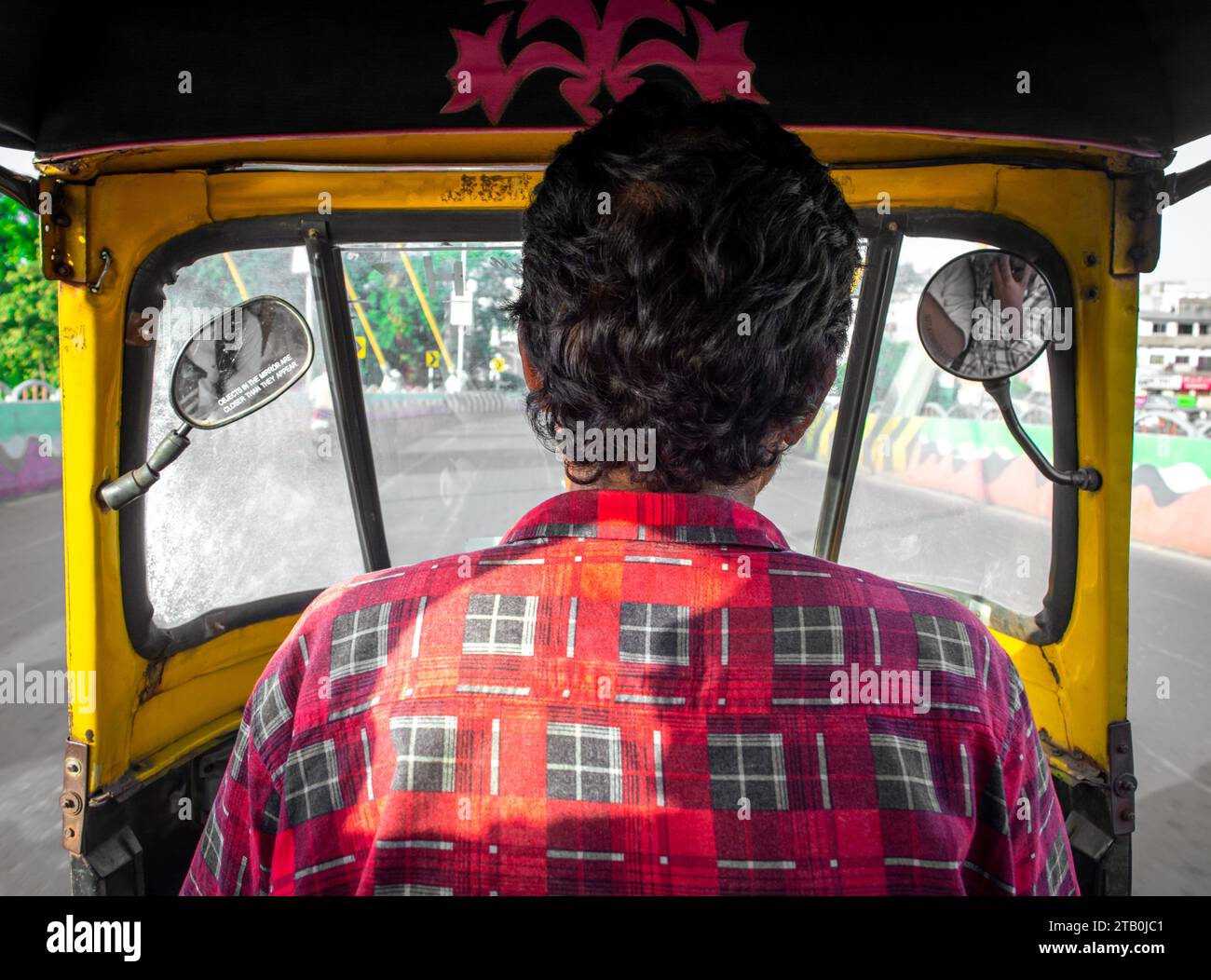 TIKAMGARH, MADHYA PRADESH, INDIA - NOVEMBER 20, 2023: View from the inside of an auto rickshaw as a passenger. Stock Photo