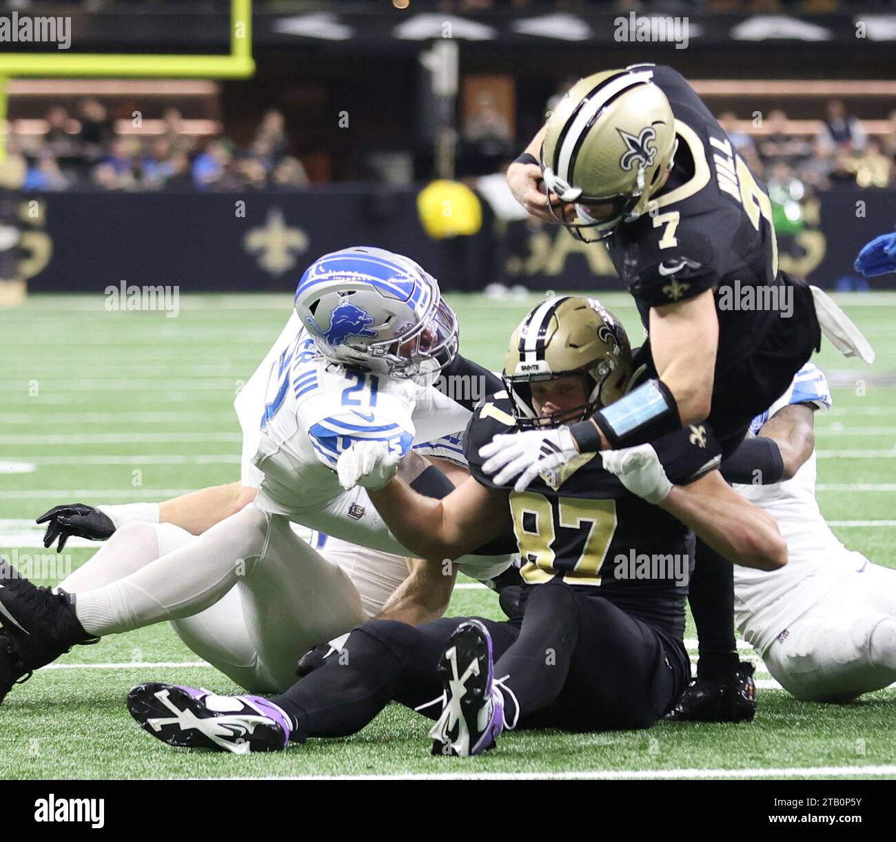 New Orleans, USA. 03rd Dec, 2023. New Orleans Saints quarterback Taysom Hill (7) tries to stretch for more yardage while being tackled by Detroit Lions cornerback Cameron Sutton (1) and safety Tracy Walker III (21) during a National Football League game at Caesars Superdome in New Orleans, Louisiana on Sunday, December 3, 2023. (Photo by Peter G. Forest/Sipa USA) Credit: Sipa USA/Alamy Live News Stock Photo