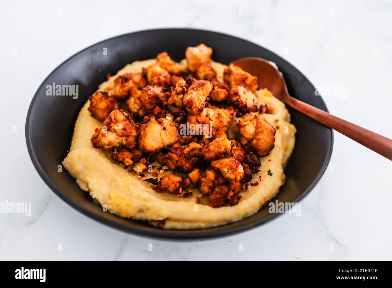 plant-based polenta with marinated tofu chunks, healthy vegan food recipes Stock Photo