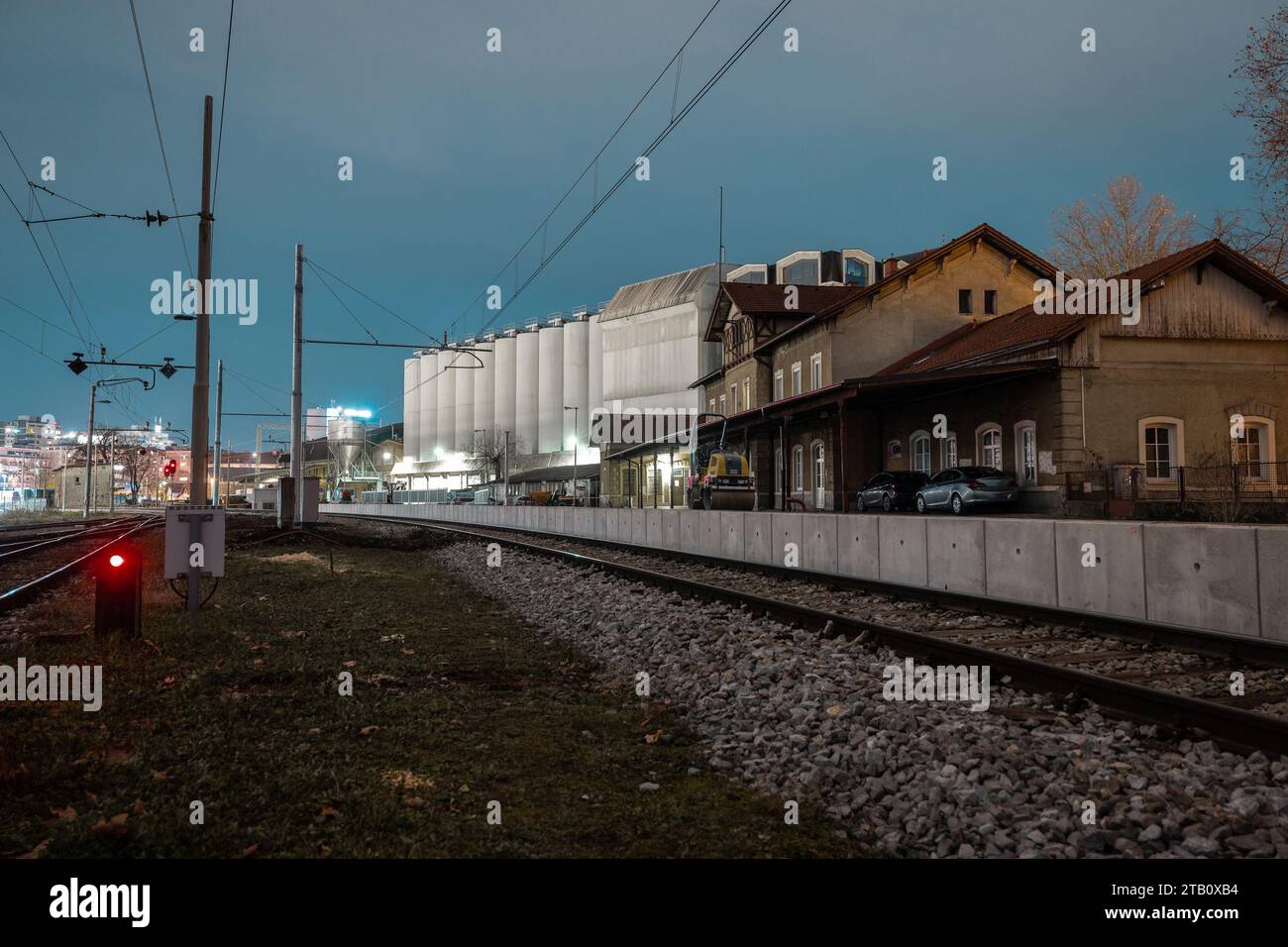 Renovating the historical train station of  Ljubljana Siska, making temporary platforms next to the railway track, putting down asphalt and rolling it Stock Photo