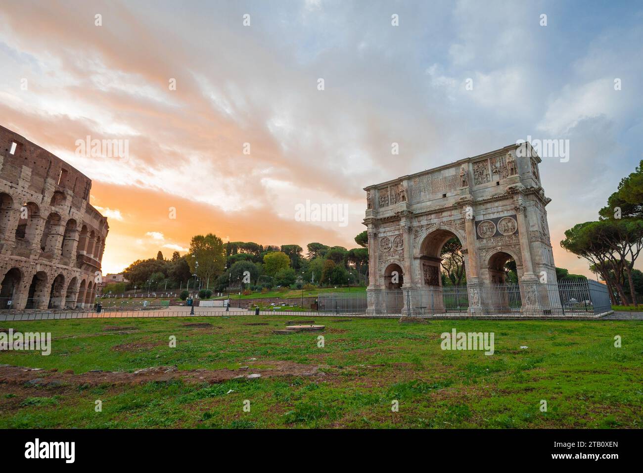 Arco di Constantino or Constantine's arch in ancient rome, big arch spanning just next to the famous colloseum, in early morning hours with sun just a Stock Photo