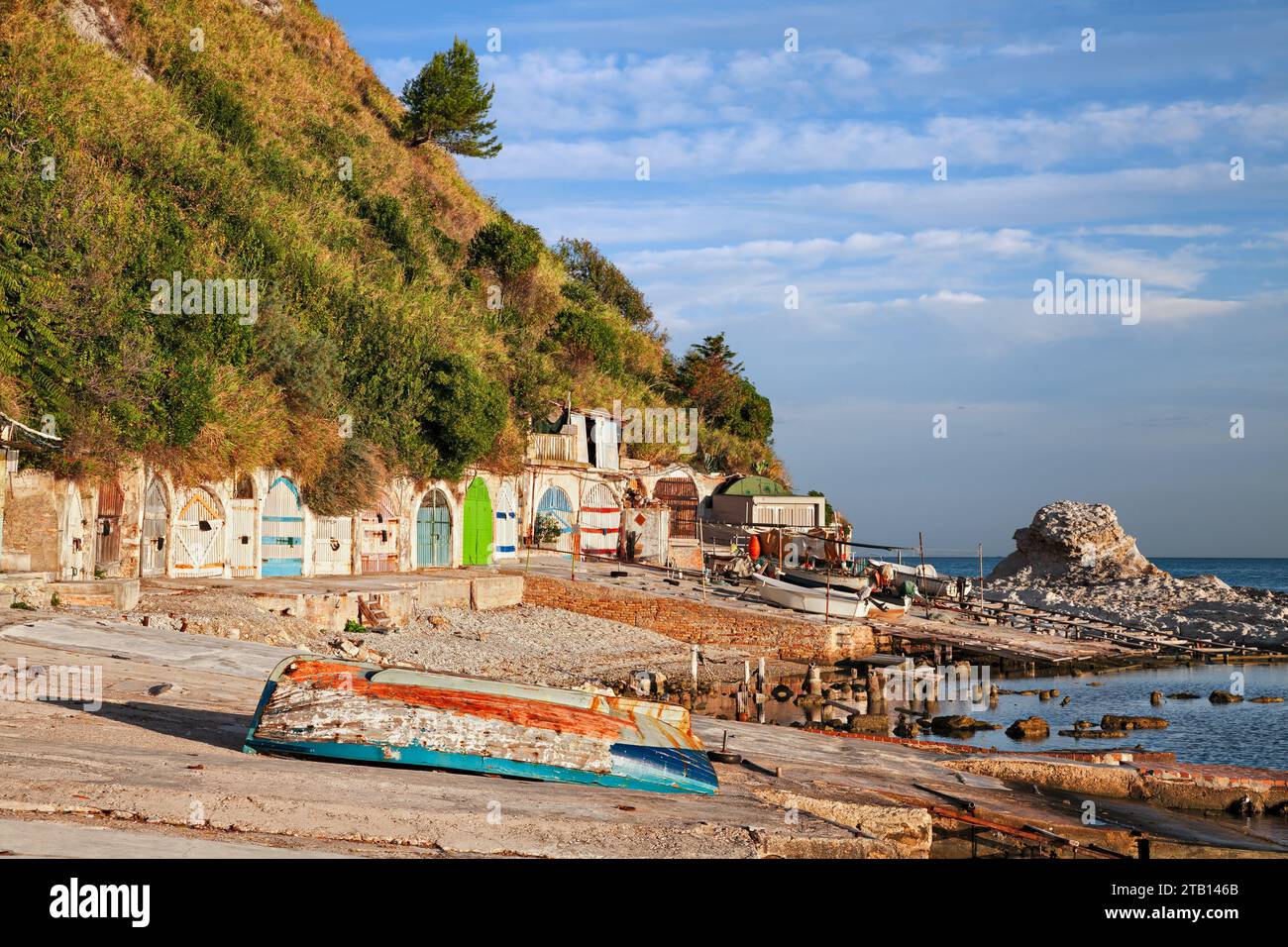 Ancona, Marche, Italy: the metropolitan beach of Passetto with the colorful doors of the caves carved into the rock to shelter the fishing boats Stock Photo