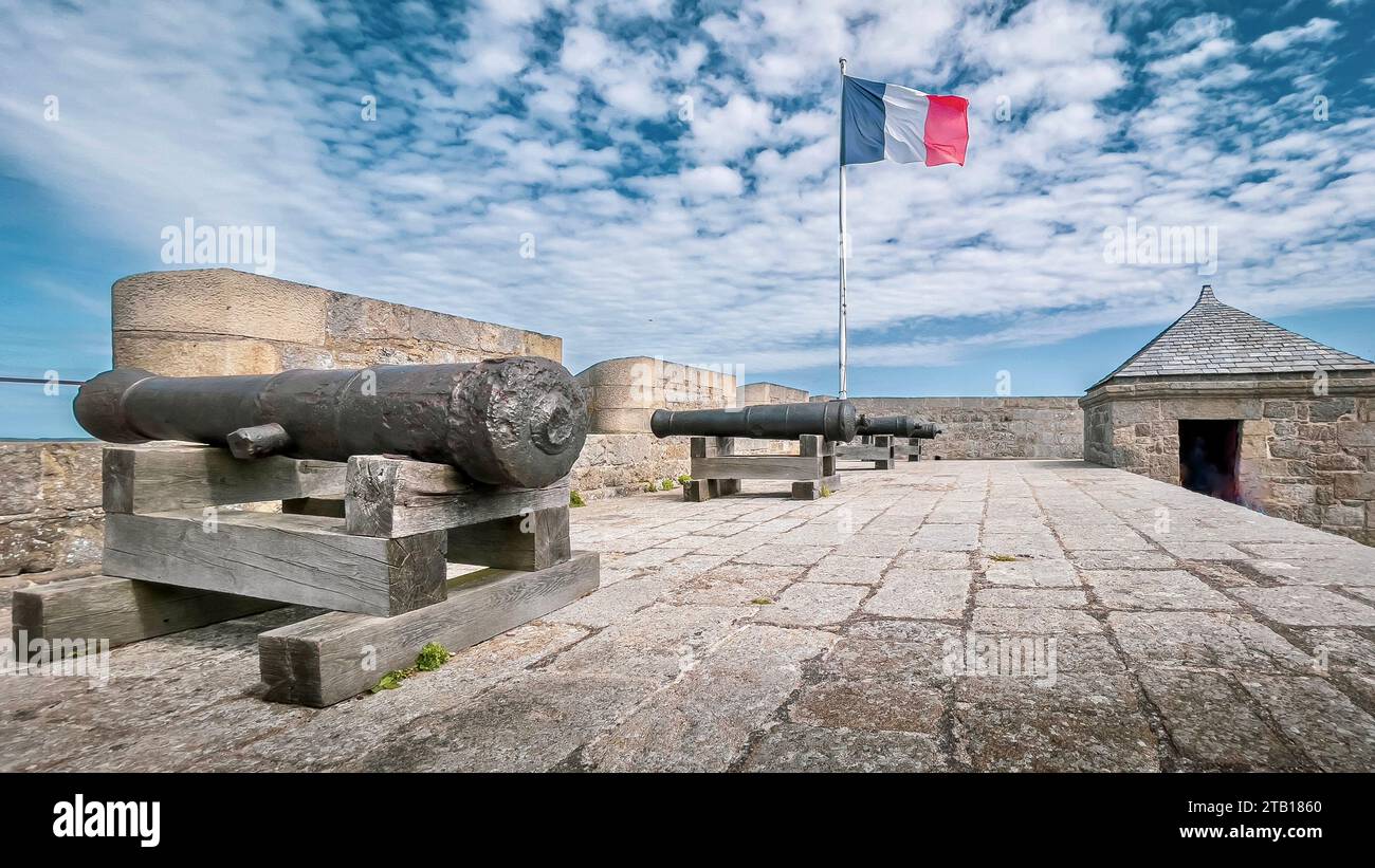 An array of antiquated cannons rest on an aged brick wall in Saint-Malo, France Stock Photo