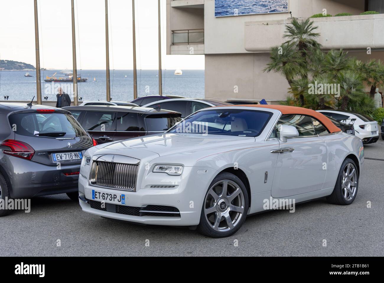 Monaco, Monaco White and orange RollsRoyce Dawn parked in front of