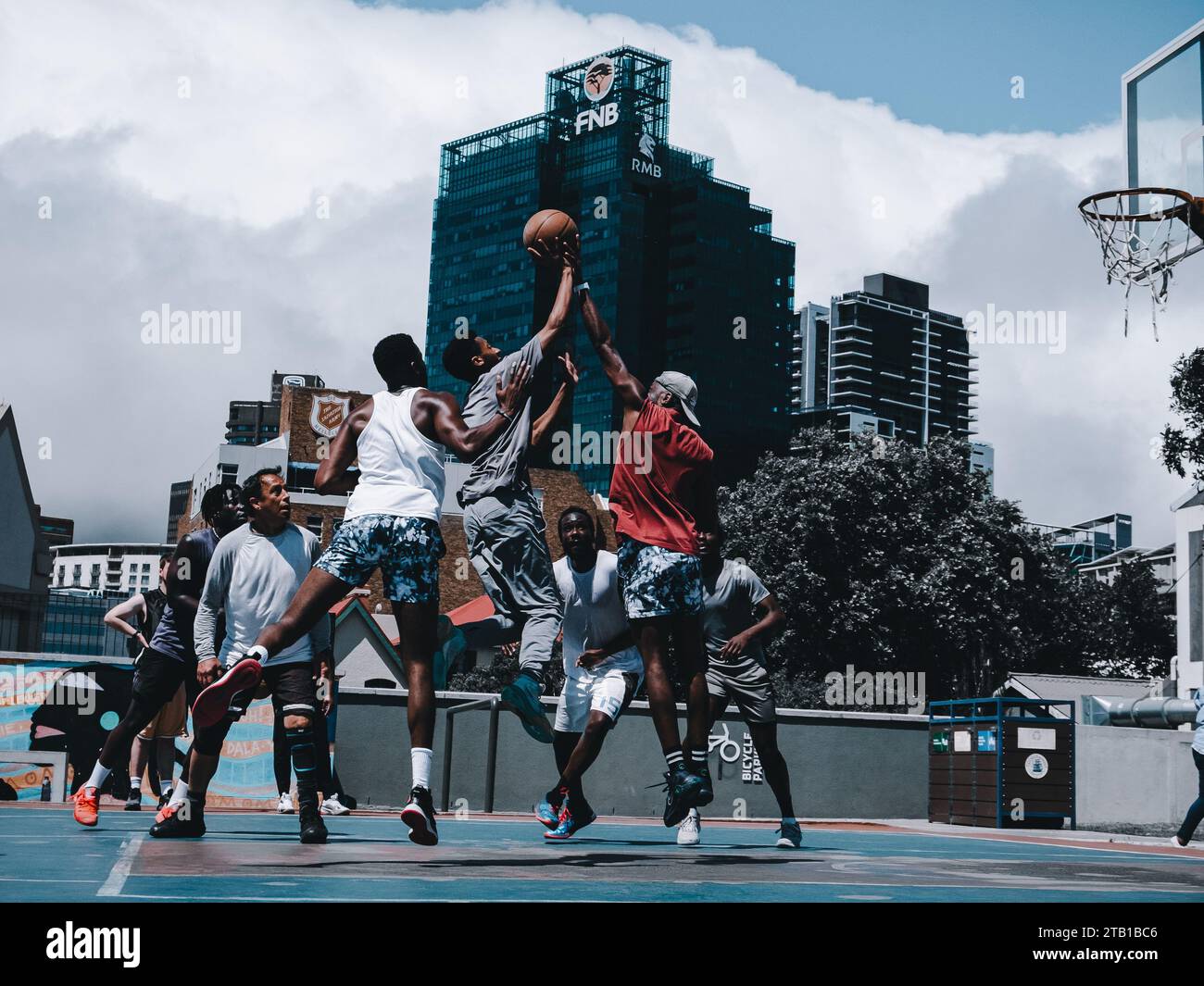 Group of People Playing Basketball in Battery Park , Cape Town Stock Photo