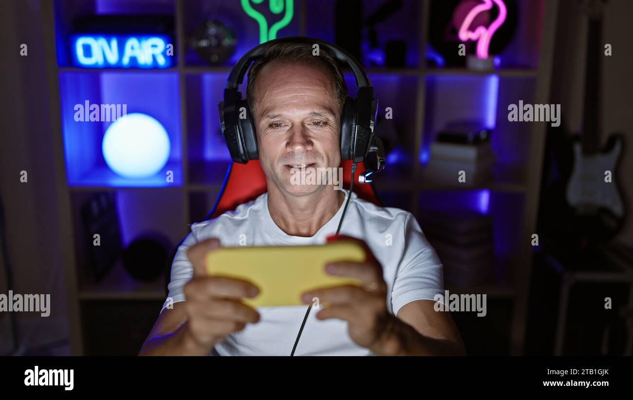 Confident middle age man streamer happily dominating his game on