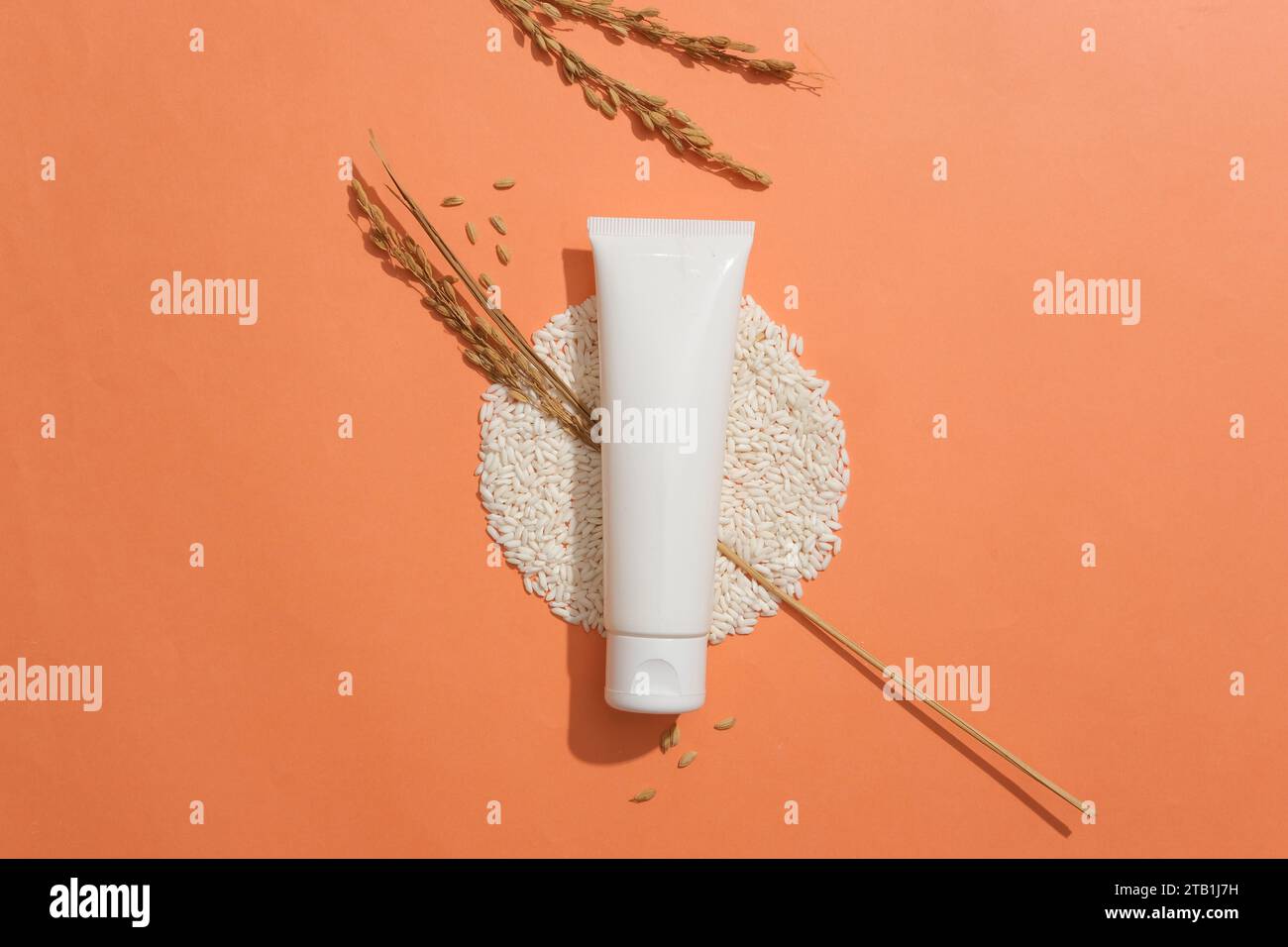 Product Sample Without Label Image A tube without label placed on a pile of rice and decorated with wheat ...