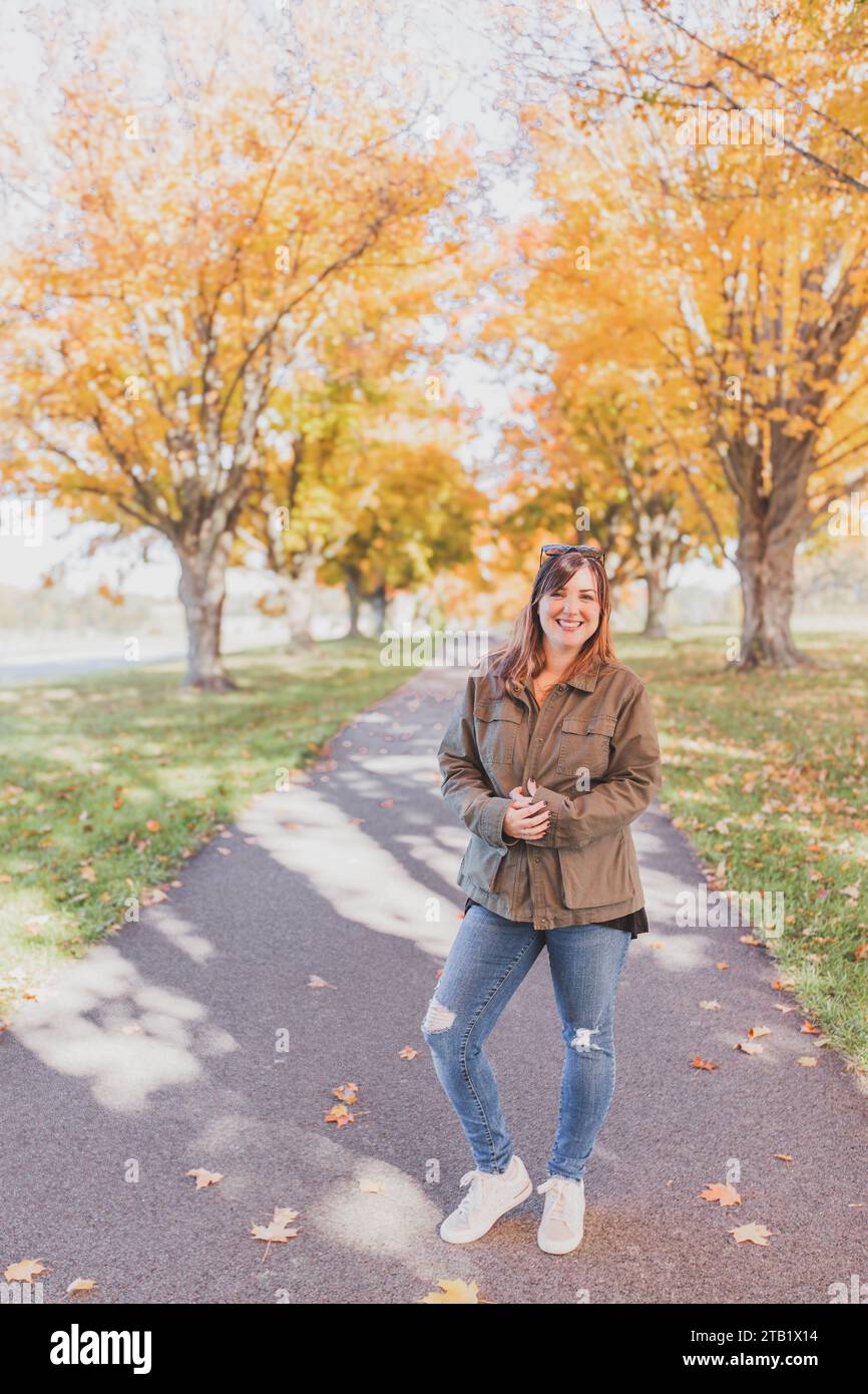 Woman Smiling outside on Autumn Day Stock Photo