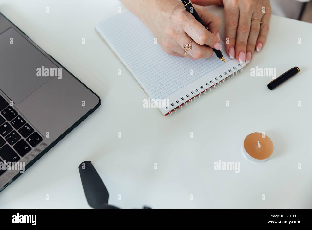 Female hands on office desk making notes on paper Stock Photo