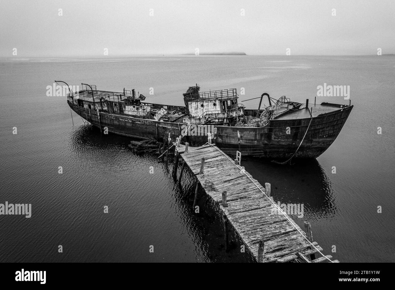 black and white image of shipwreck and dock, Castine, Maine Stock Photo