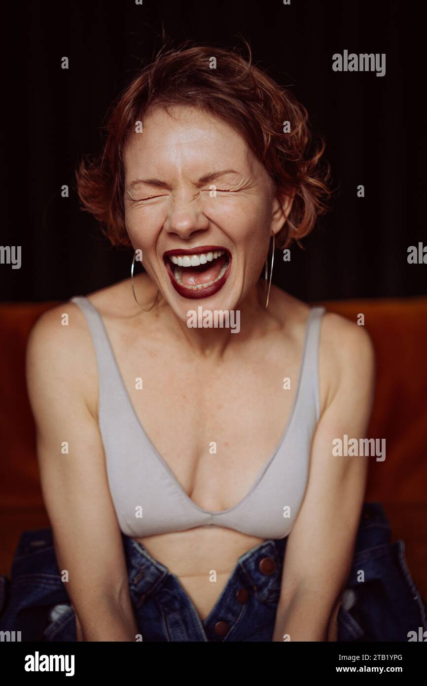 Young brunette woman screams, emotional portrait. Stock Photo