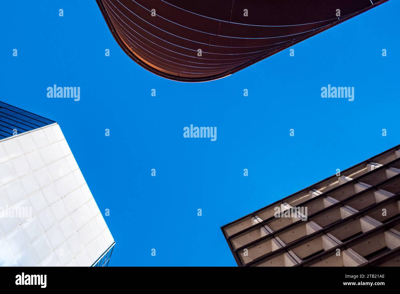 Looking up to three different commercial buildings in central Sydney, Australia, leaning in or converging towards the centre of the image Stock Photo