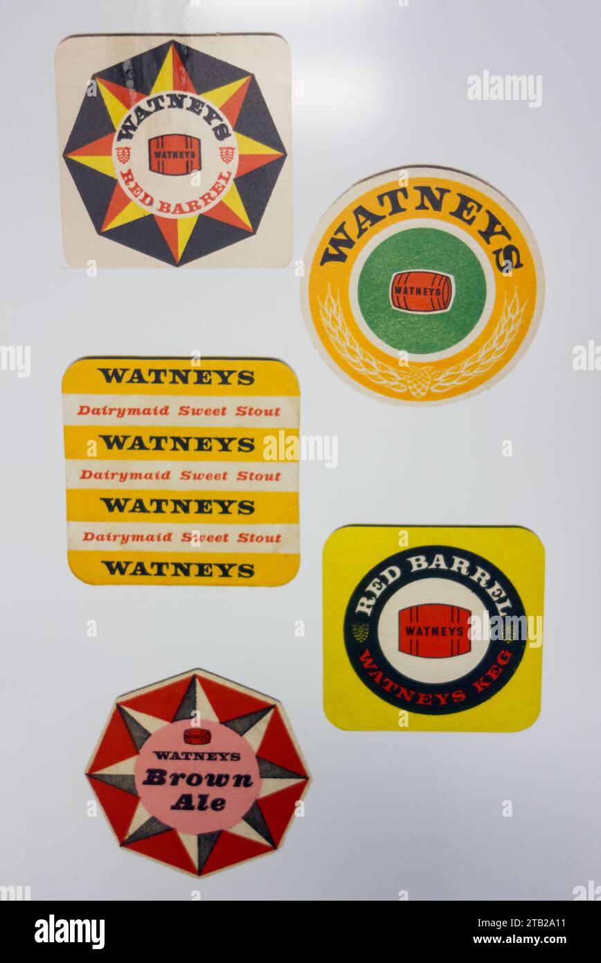 Closeup of an assortment of colourful Watney's brewery beer mats Stock Photo