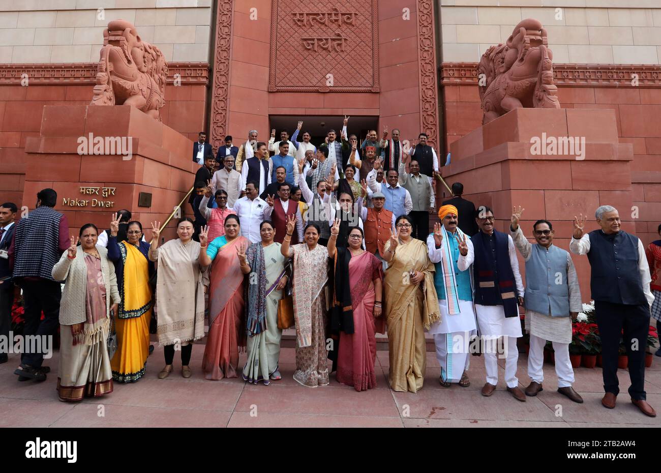 Members of Parliament (lawmakers) from the Bharatiya Janata Party show victory signs standing outside the new Parliament building on the first day of the Parliament winter session 2023, at Parliament House. Prime Minister Modi said the opposition should learn from defeat and consider this a golden opportunity and move forward with positivity this session. (Photo by Naveen Sharma / SOPA Images/Sipa USA) Stock Photo