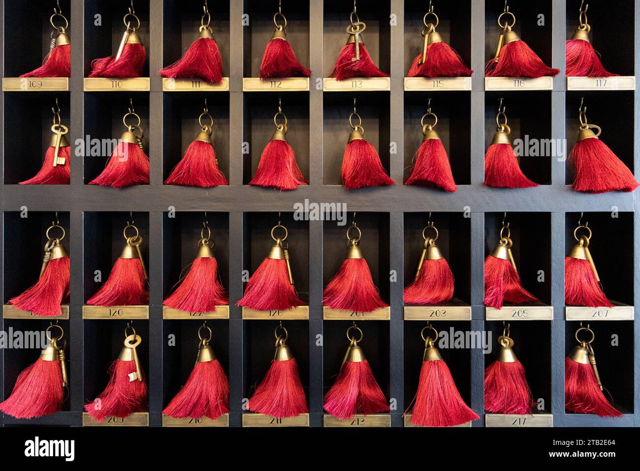 Traditional red key tags in hotel on display Stock Photo - Alamy