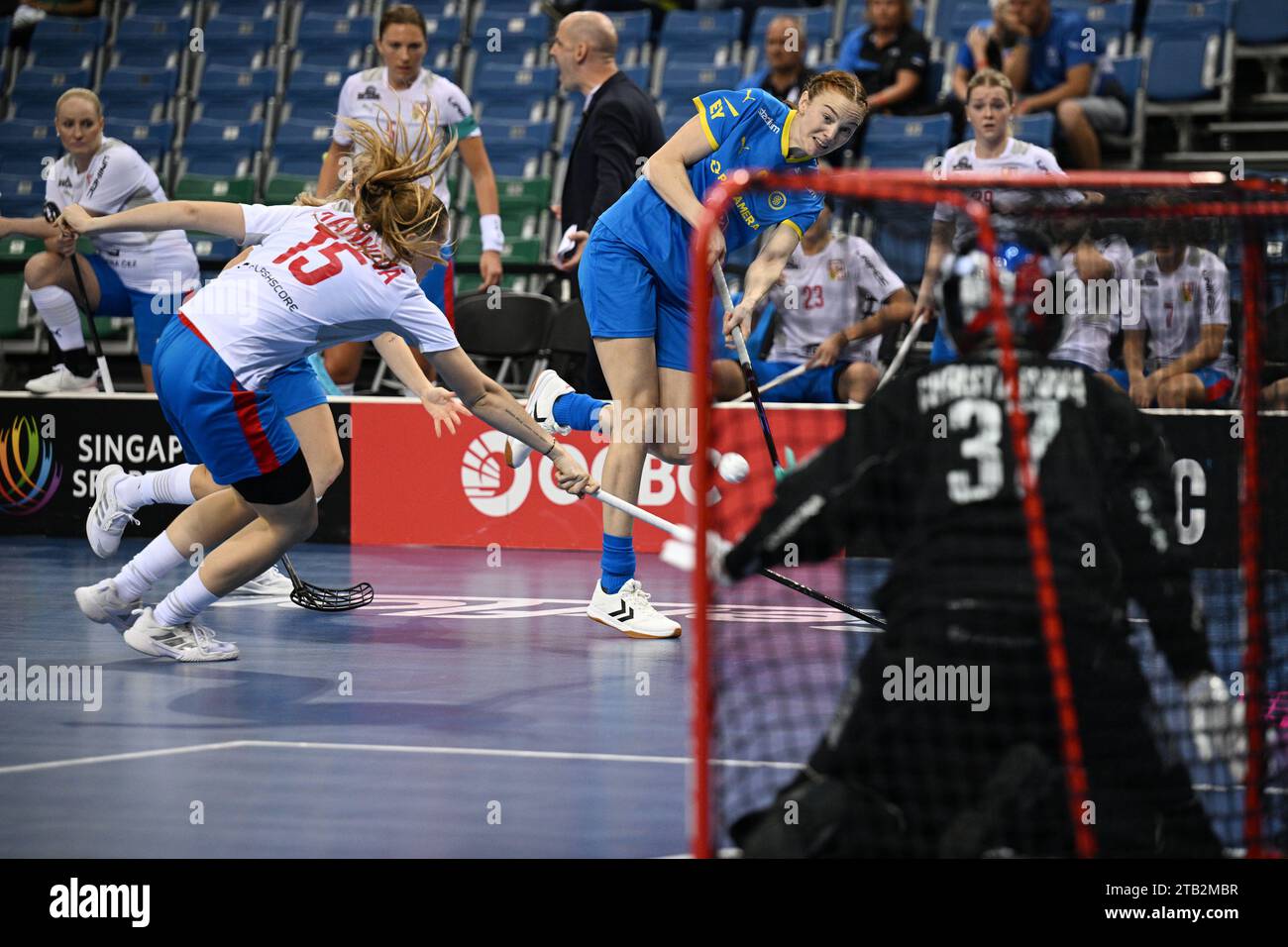 Singapore. 4th Dec, 2023. Ellen Rasmussen (R) of Sweden attempts a shot at goal during the group B match between the Czech Republic and Sweden at the International Floorball Federation's (IFF) Women's World Floorball Championship in Singapore on Dec.4, 2023. Credit: Then Chih Wey/Xinhua/Alamy Live News Stock Photo