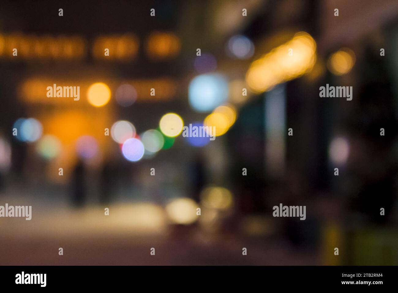 town street at night in winter holiday season. blurred festive urban background with bokeh effect Stock Photo