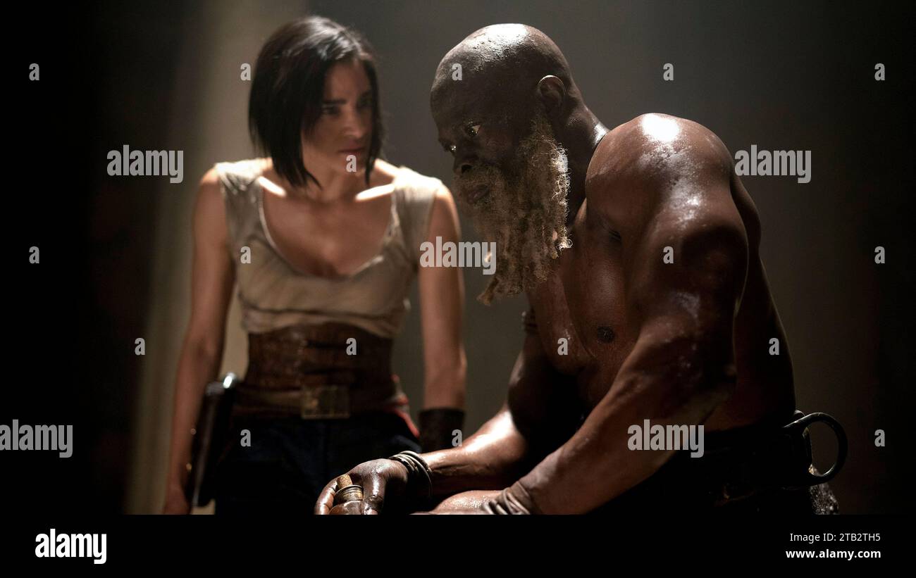 Rebel Moon: Part One - A Child of Fire (2023) directed by Zack Snyder and starring Sofia Boutella as Kora and Djimon Hounsou as General Titus. When a peaceful settlement on the edge of a distant moon finds itself threatened by the armies of a tyrannical ruling force, a mysterious stranger living among its villagers assembles a small band of warriors to fight back. Publicity still ***EDITORIAL USE ONLY***. Credit: BFA / Netflix Stock Photo