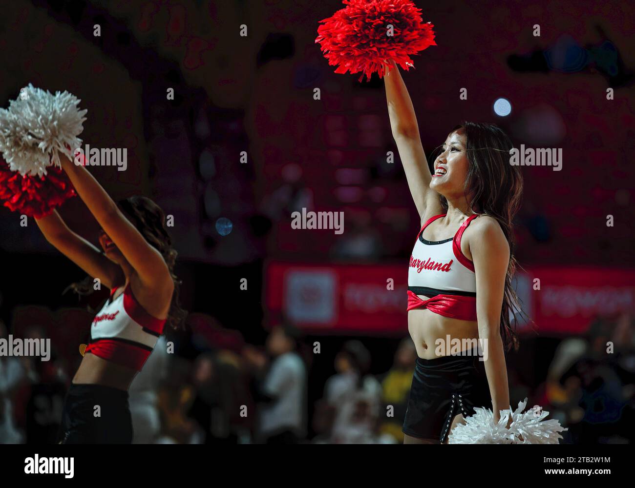 A cheerleader performs at a college basketball game Stock Photo
