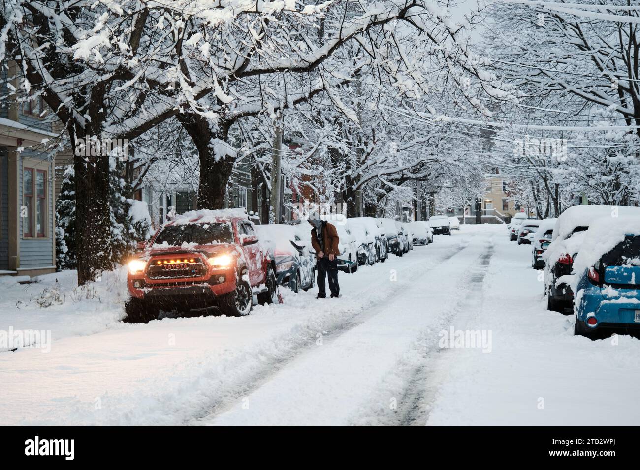 Halifax, Nova Scotia, Canada. December 4th, 2023. Early rider clearing his truck to get to work, With over 20cm of snow falling overnight the city awakes to its first snow storm day of the winter. Credit: meanderingemu/Alamy Live News Stock Photo