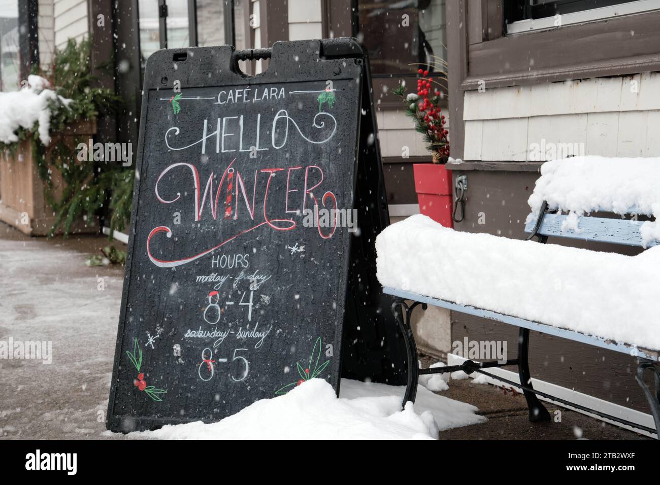 Halifax, Nova Scotia, Canada. December 4th, 2023. Café sign welcoming winter as Halifax wakes up from 20cm of snow falling overnight its first snow storm day of the winter. Café Lara will be opened today for those that visit. Stock Photo