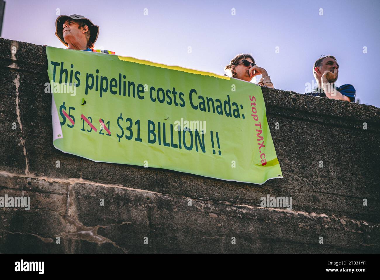 Vancouver, Canada - September 15,2023; View of sign This pipiline costs Canada $31 billion as part of Global Climate Strike in front of Vancouver City Stock Photo
