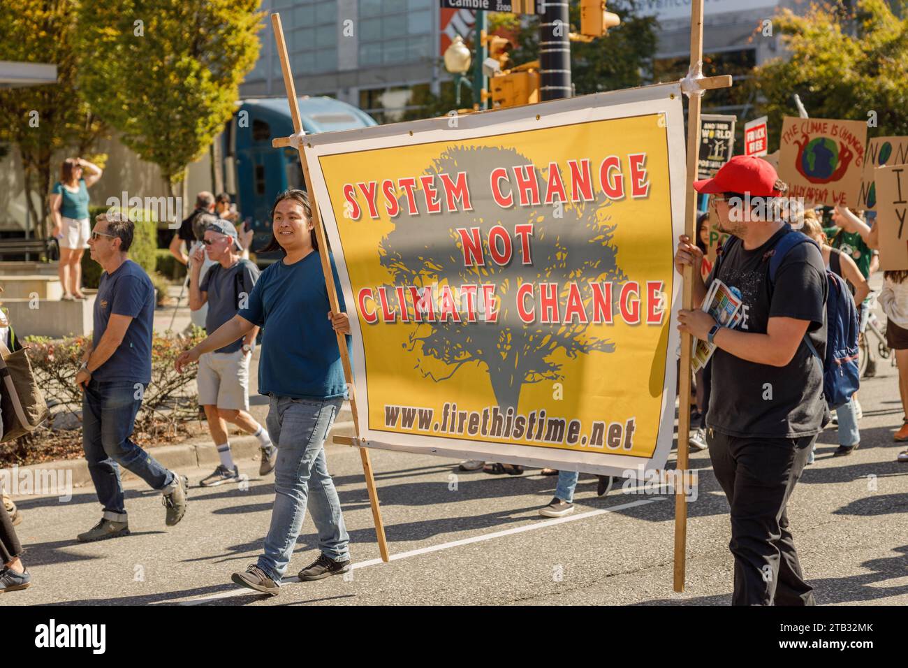 Vancouver, Canada - September 15,2023: Activists with a sign: System change not climate change walking down Cambie Street as part of the Global Climat Stock Photo