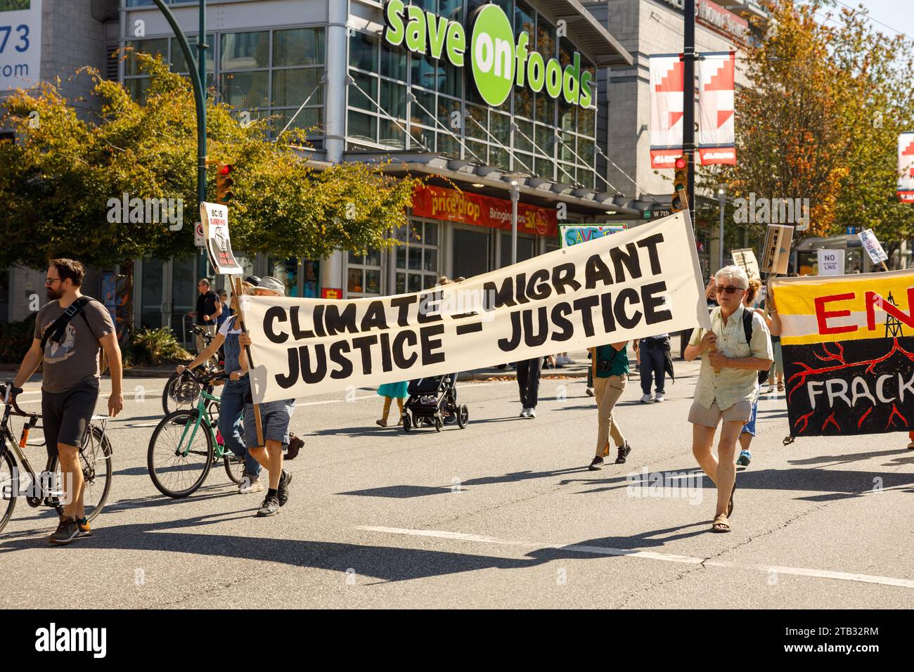 Vancouver, Canada - September 15,2023: Activists with a sign: Migrant Justice Climate Justice walking down Cambie Street as part of the Global Climate Stock Photo
