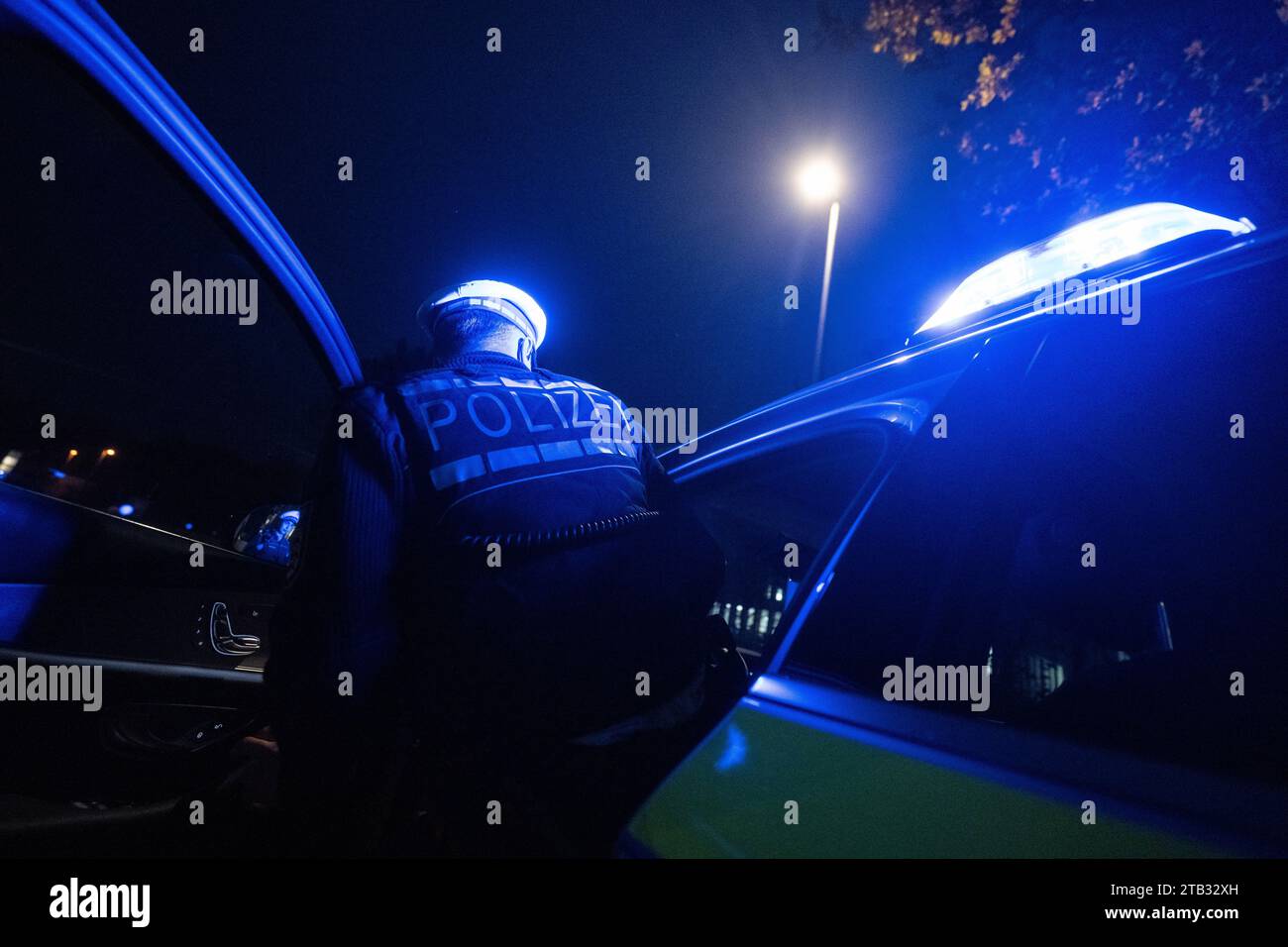 Stuttgart, Germany. 30th Nov, 2023. A police officer gets into a police ...
