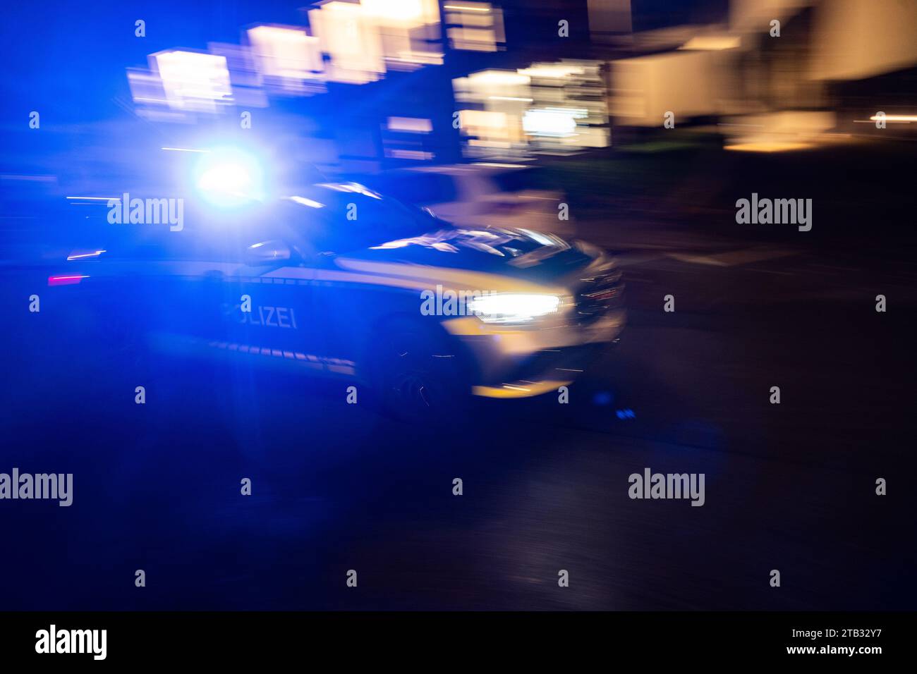 Stuttgart, Germany. 30th Nov, 2023. A police car drives past a building ...