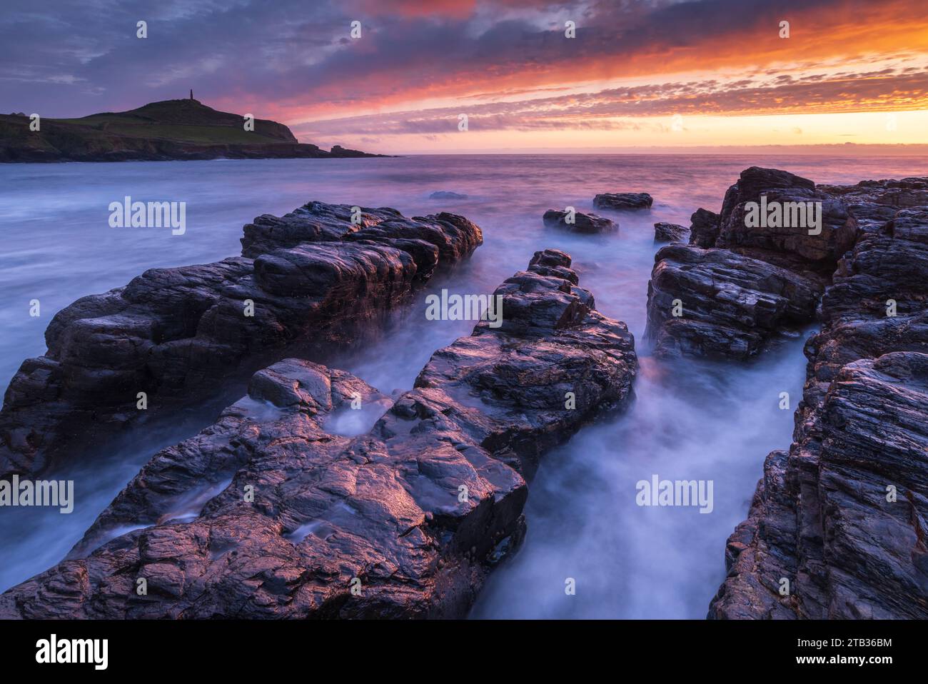 Sunset over Cape Cornwall from the rocky shores of Porth Ledden, Cornwall, England. Spring (May) 2022. Stock Photo