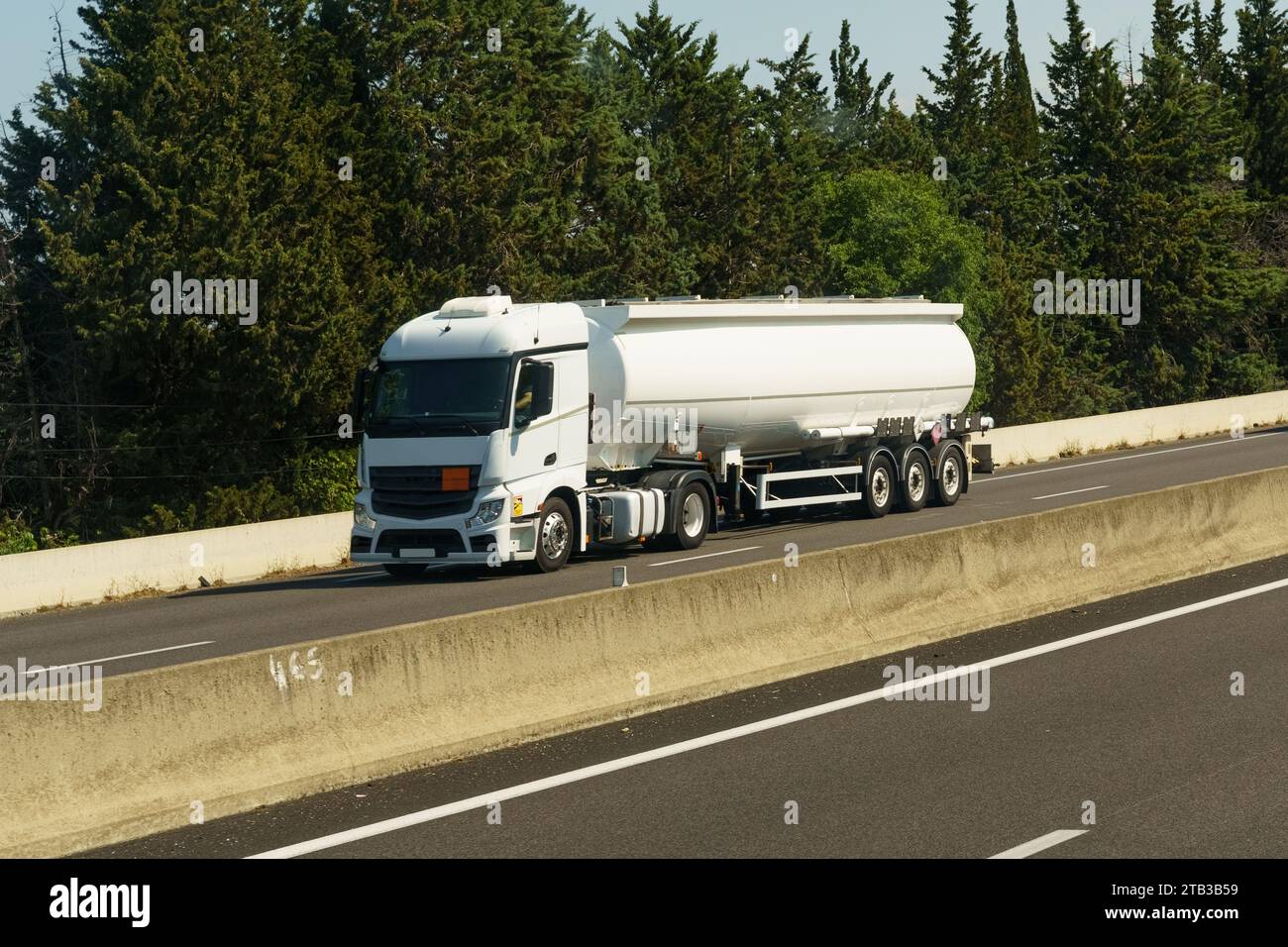 Transportation of liquid chemical products by road along the highway. Logistics concept. Stock Photo