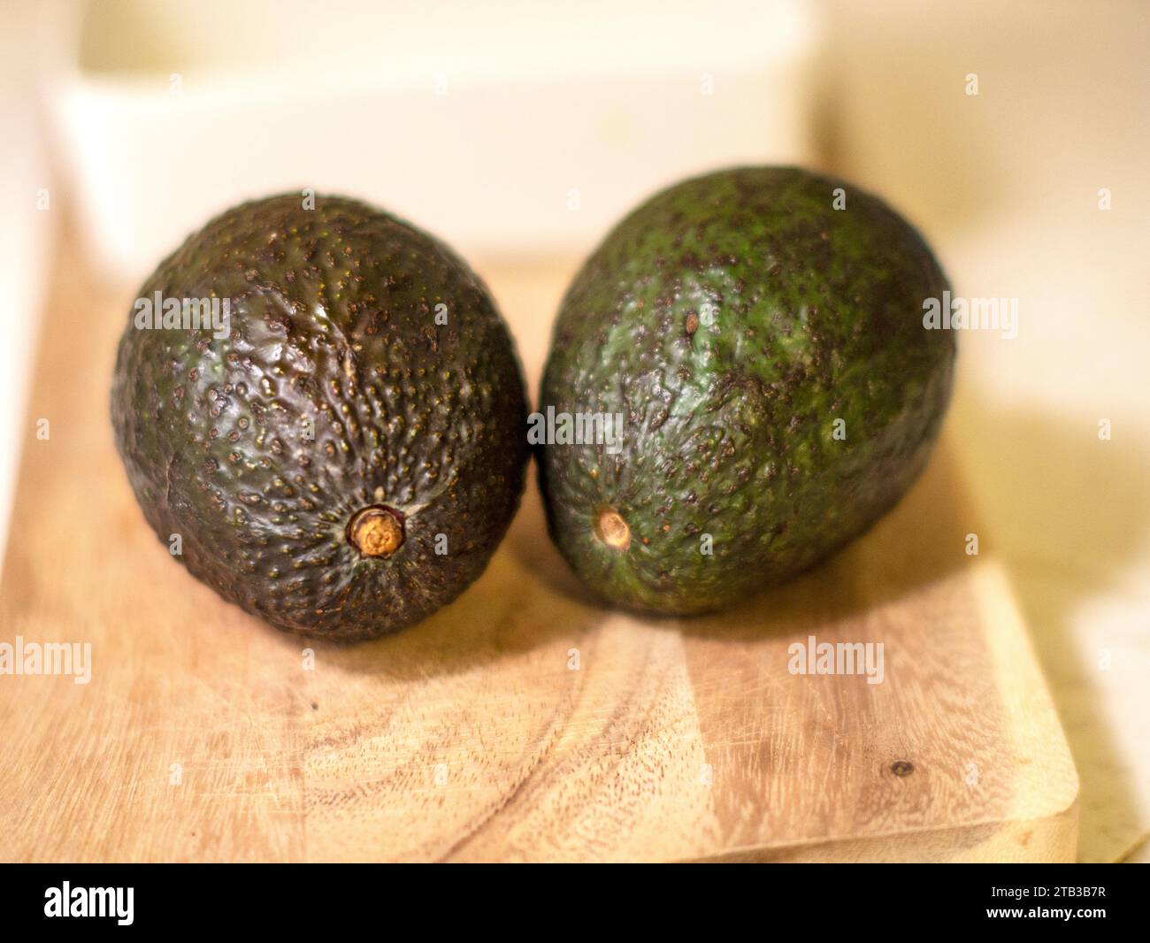 Avocados on the cutting board Stock Photo