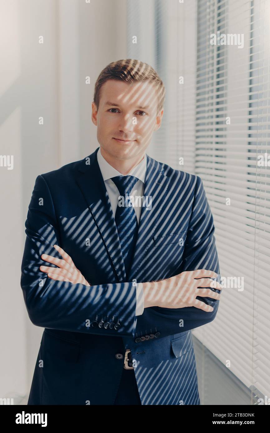 Man in suit stands arms hi-res stock photography and images - Alamy