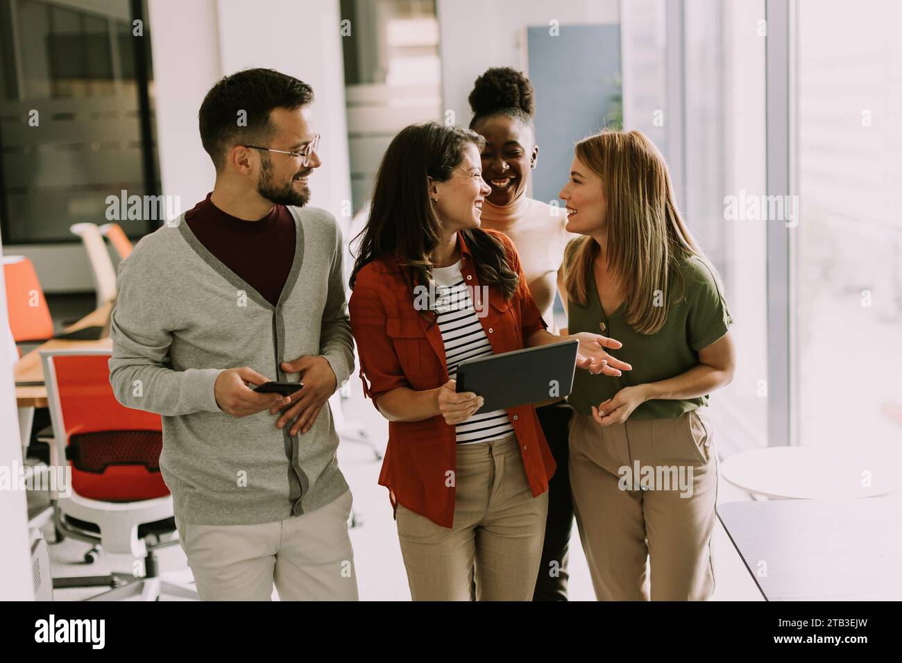 Young multiethnic startup team walking at the modern office Stock Photo