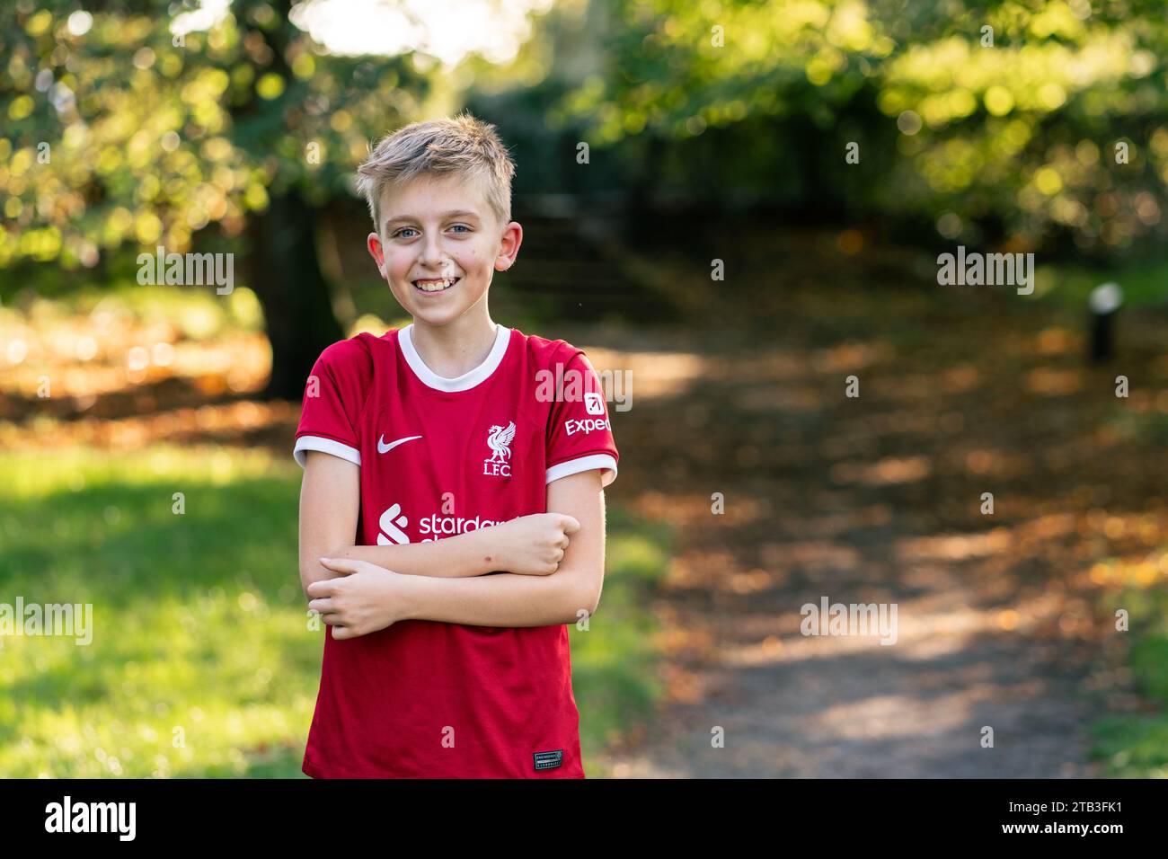 A happy child in a Liverpool jersey in a park Stock Photo
